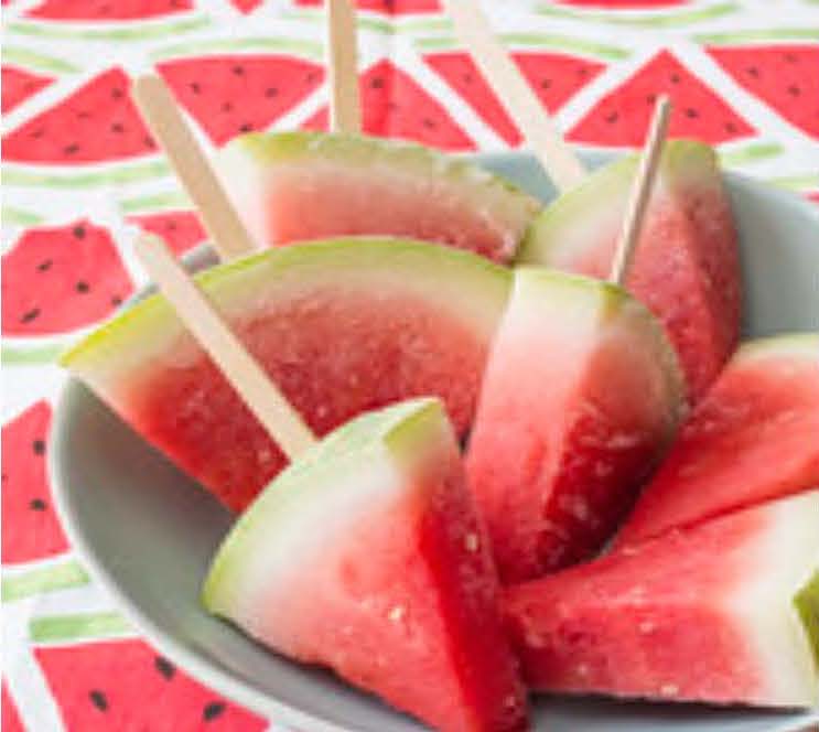 Watermelon slices with popsicle sticks frozen into them.